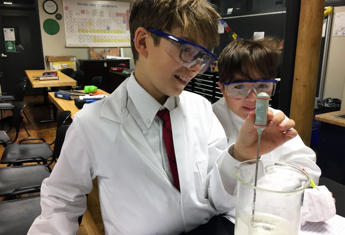 Picture of two students working on a science project in the science lab.