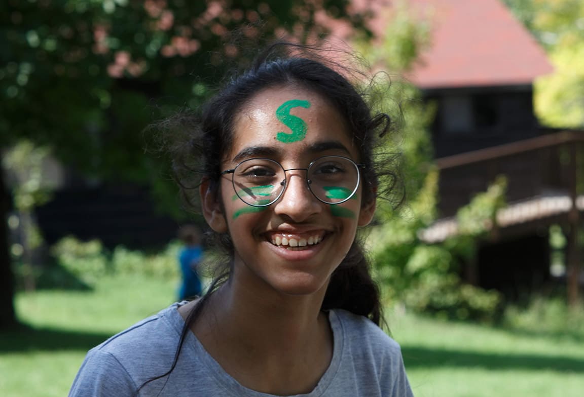 Picture of a student with Sentience House face paint at an outdoor house activity