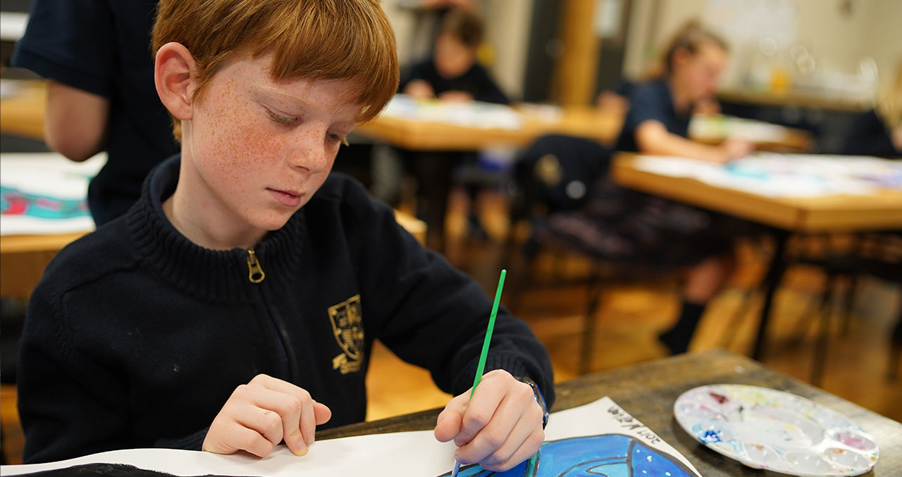 Picture of a junior school student drawing in art class