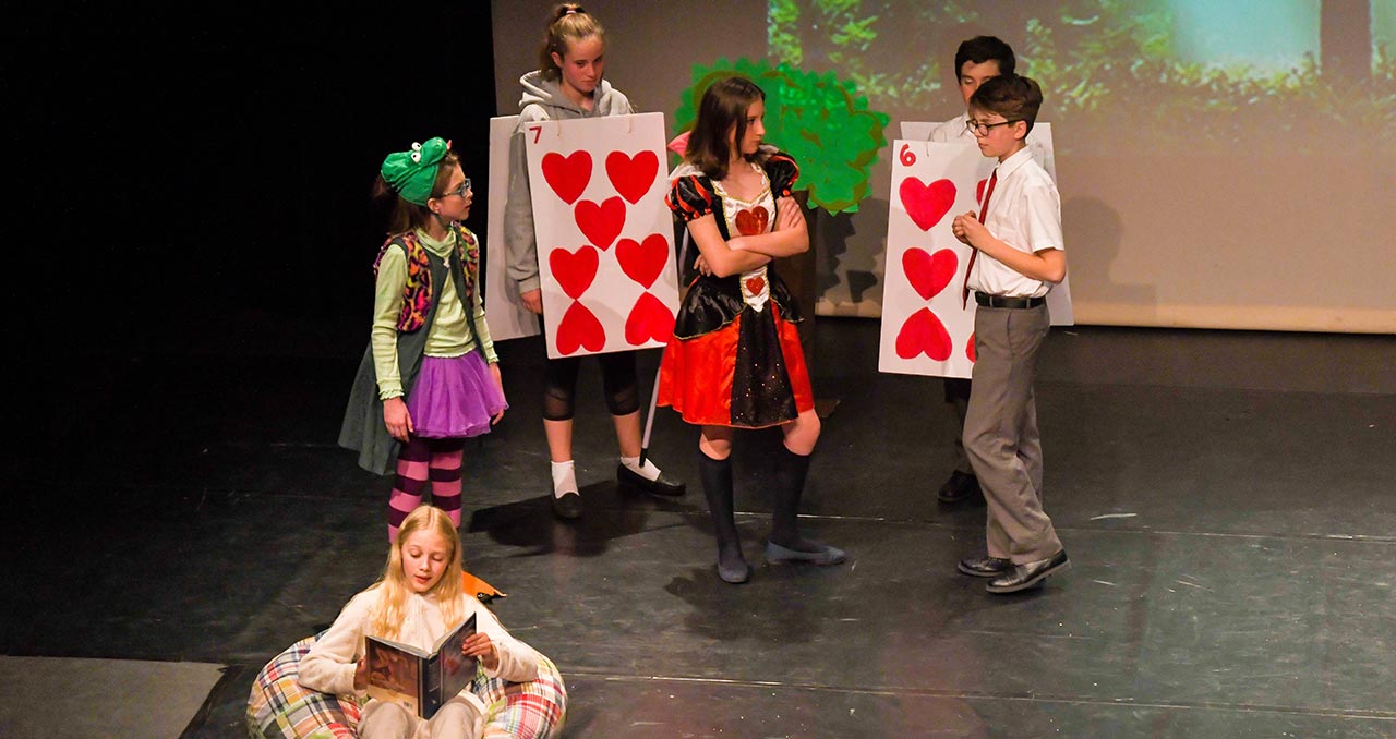 Picture of students performing a play on stage