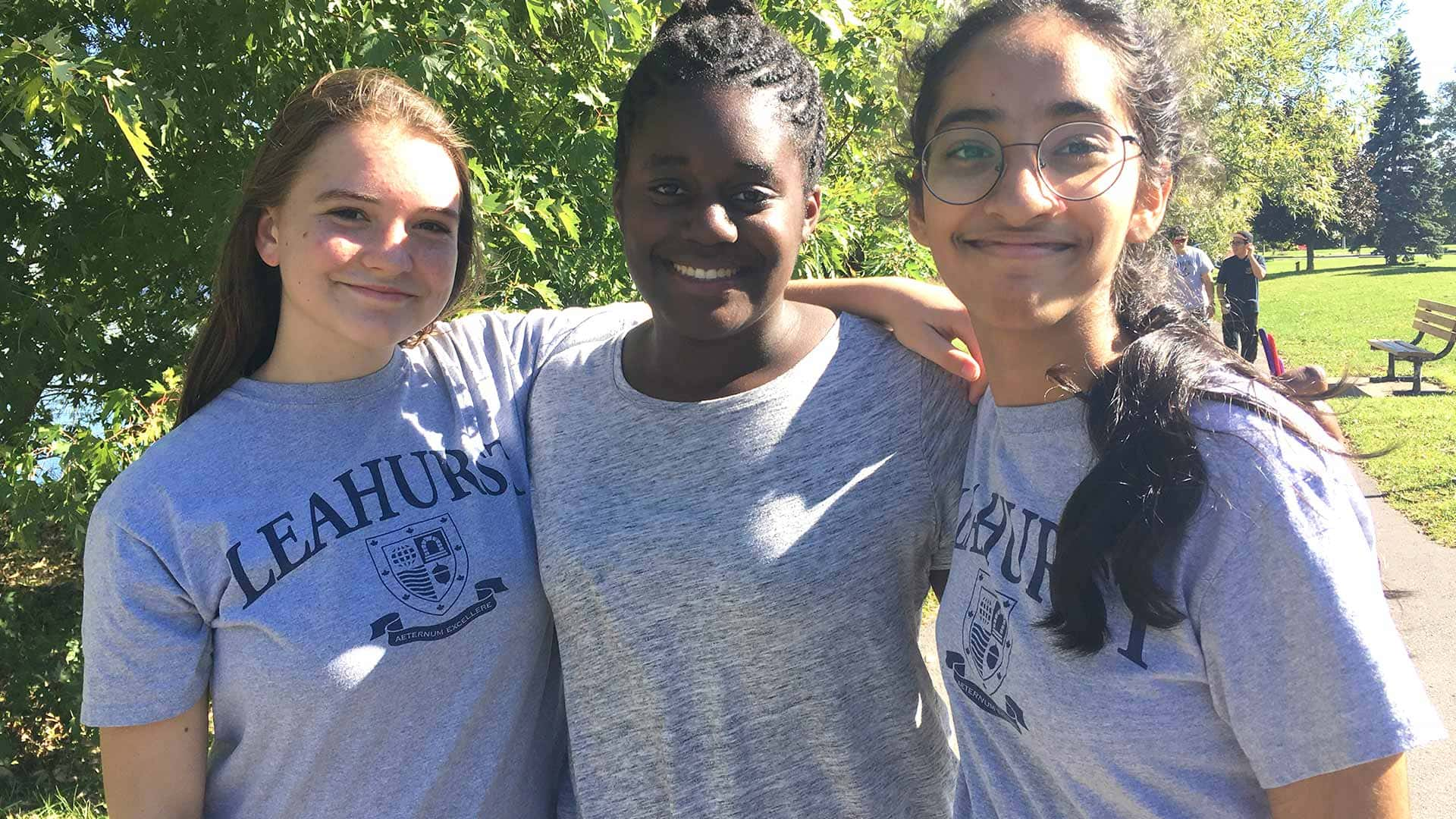 Picture of three students posing for a photo and smiling