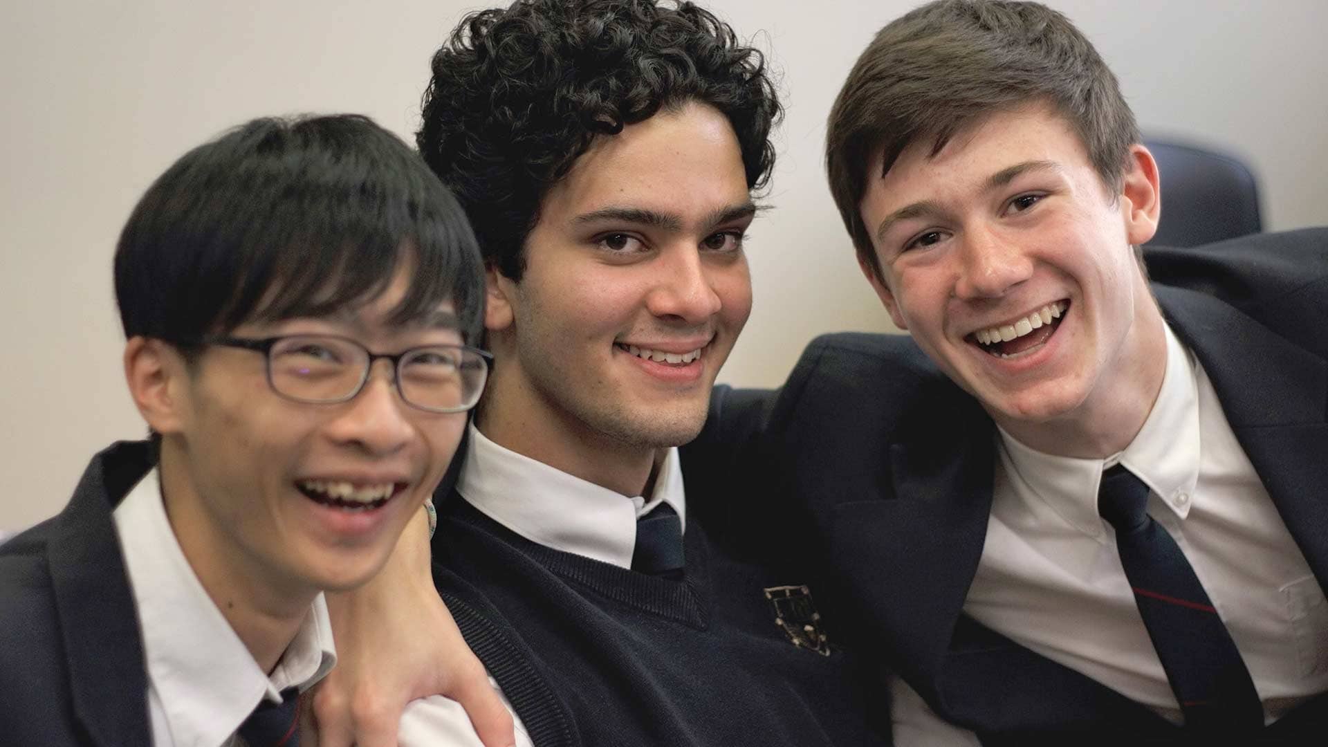 Picture of three students posing for a photo and smiling