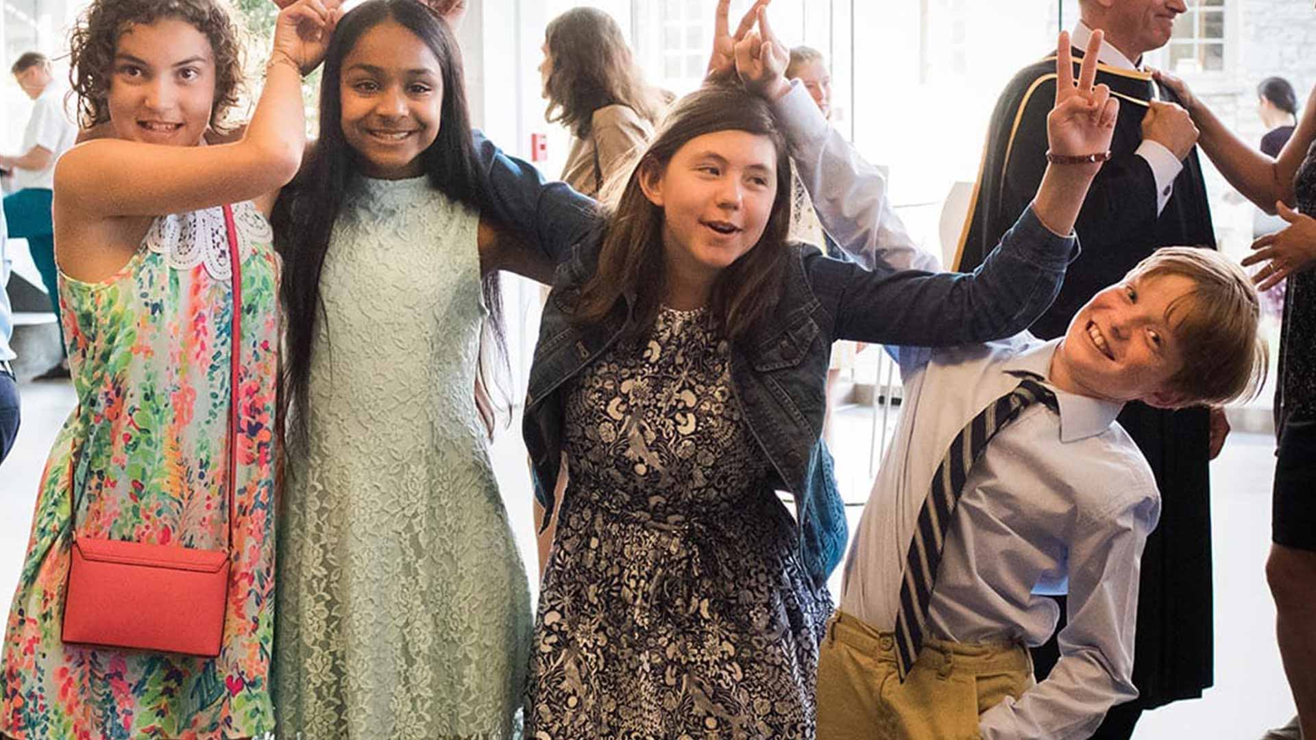 Picture of four students posing for a photo at a graduation event