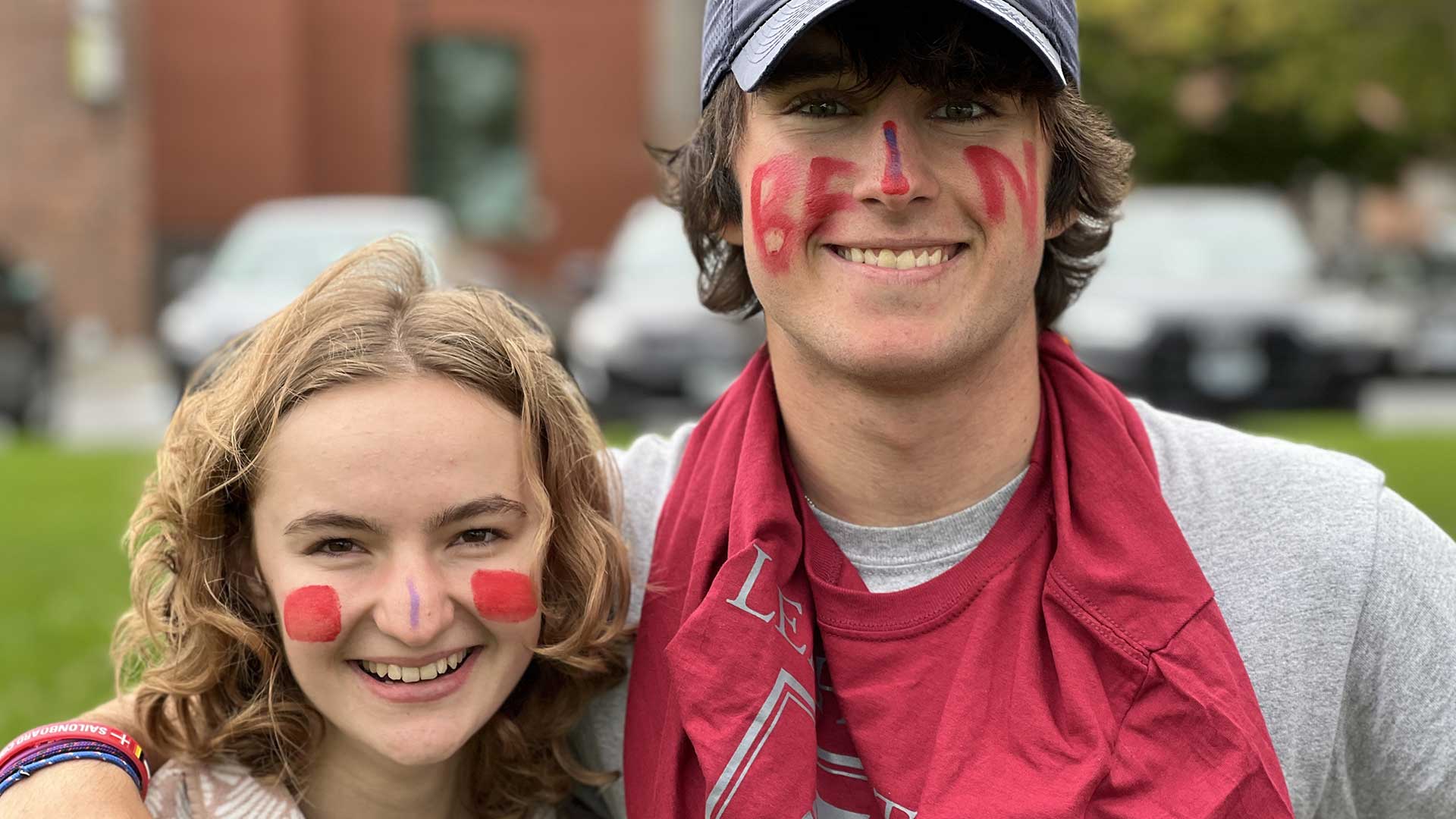 Picture of two smilling students wearing House Creativity t-shirts and face paint