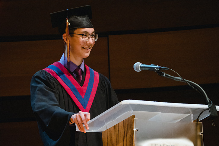 Picture of student giving a speech at graduation