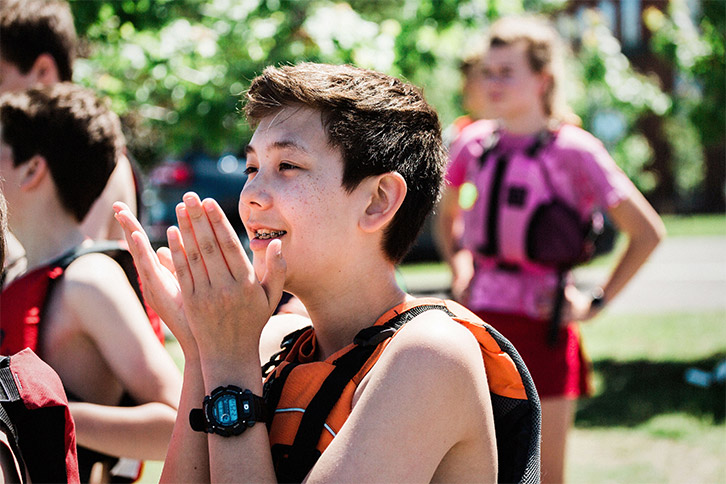 Picture of a student wearing a life vest at a school outdoor activity