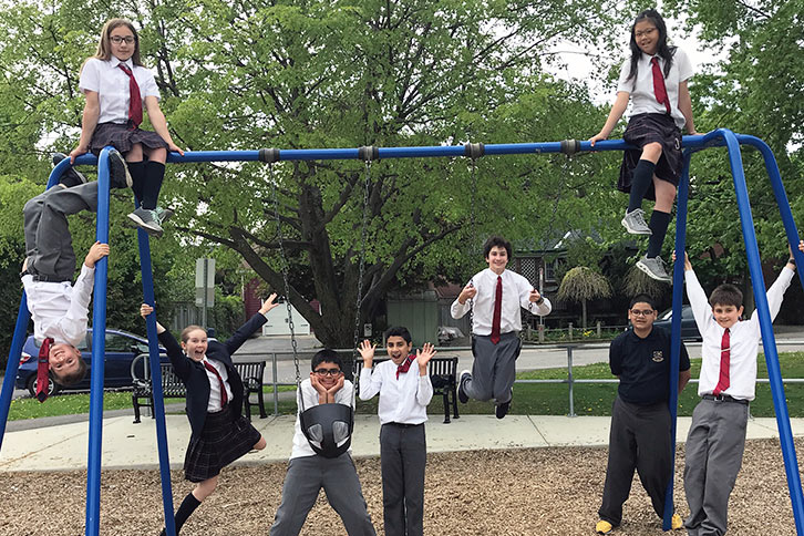 Picture of nine junior school students on a school swing