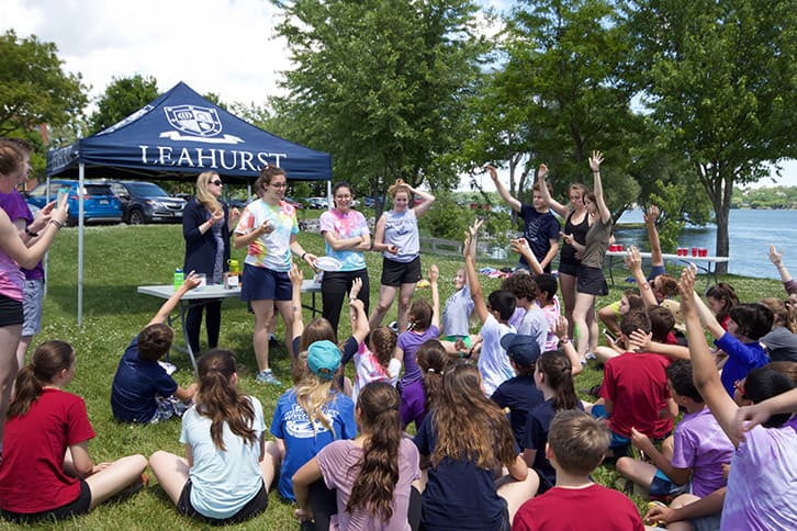 Picture of students students listening to the House event organizers giving instructions outdoors