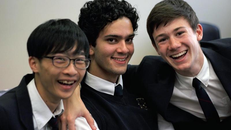 Picture of three students smilling and posing for a photo