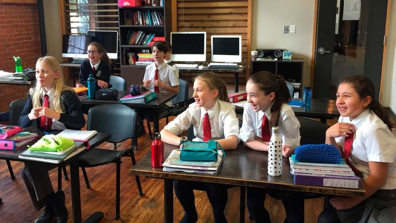 Picture of smilling students sitting in a classroom