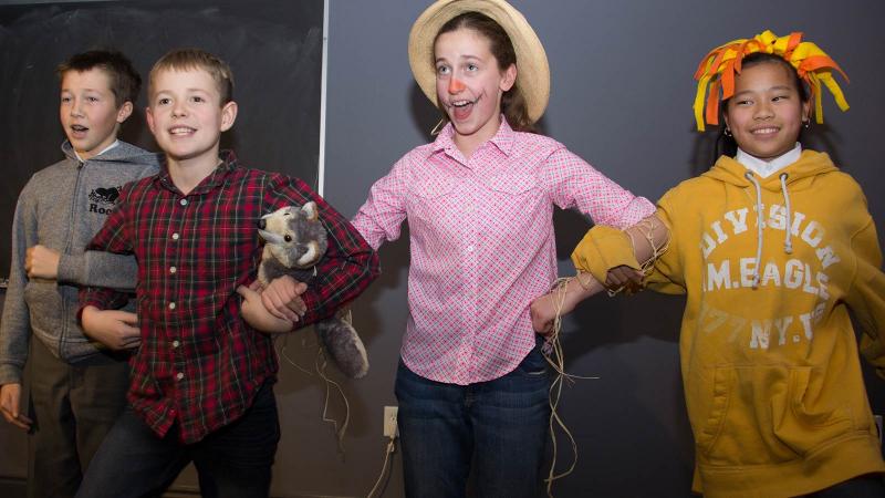 Picture of four students performing a play