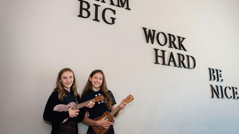Picture of two student each holding a banjo