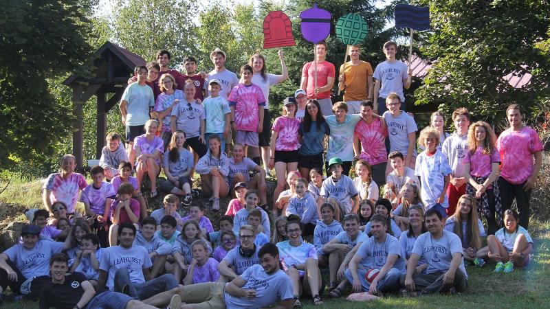 Picture of students wearing their House t-shirts and posing as a group outdoors