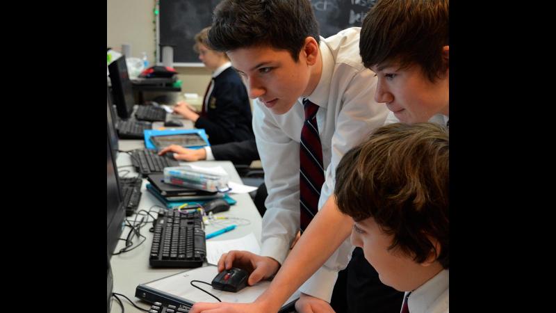 Picture of students looking at a computer screen