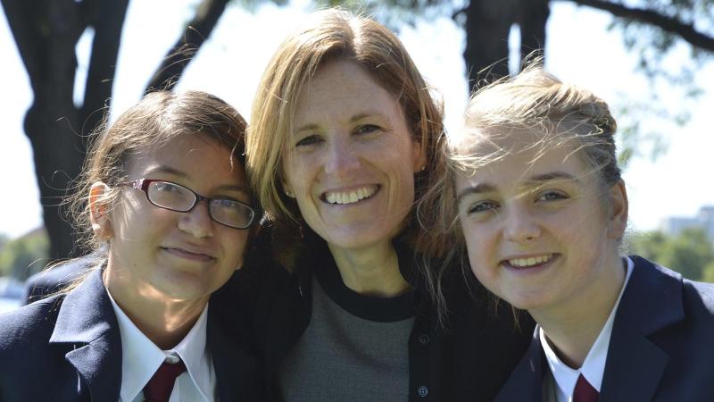 Picture of two students and the head of school outdoors