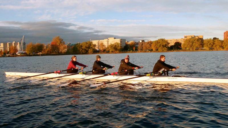 Picture of four students rowing