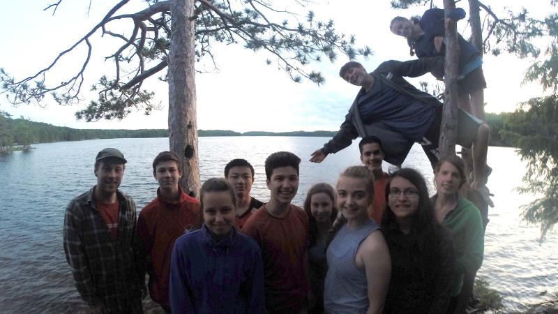 Picture of a group of students posing in front of a lake