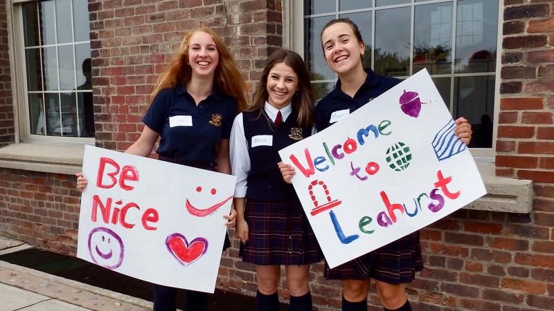 Picture of students holding up school spirit signs