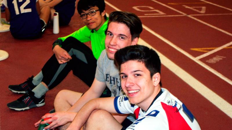 Picture of students sitting down on a run track