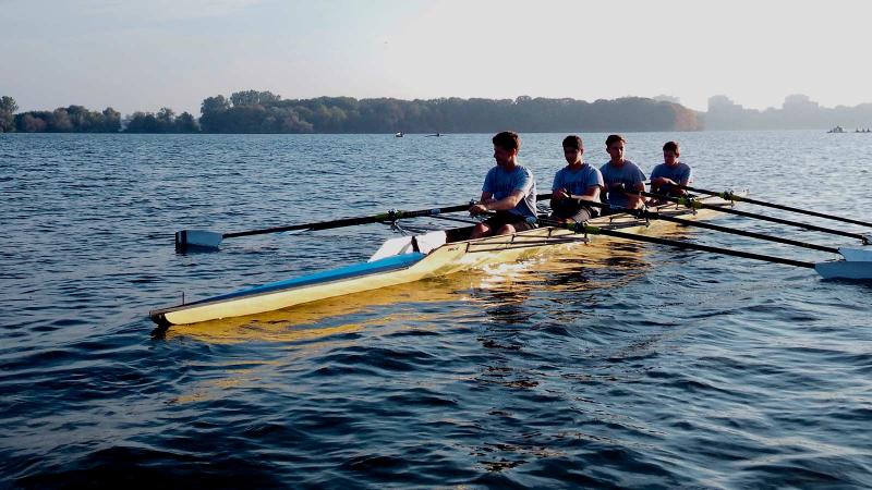 Picture of four students rowing