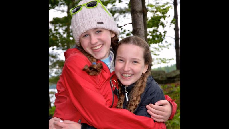 Picture of two students hugging and smilling