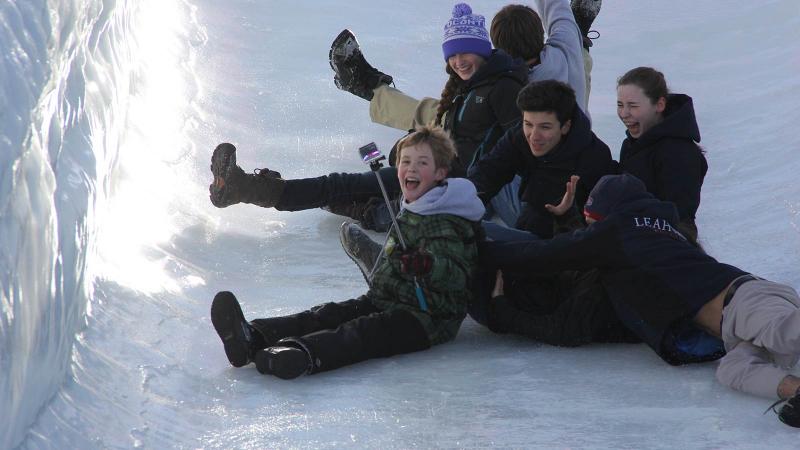 Picture of student sliding down an icy winter slide