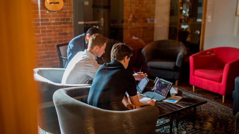 Picture of three students working on their homework