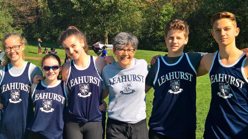 Picture of students posing for a picture outdoor with a Physical Education teacher