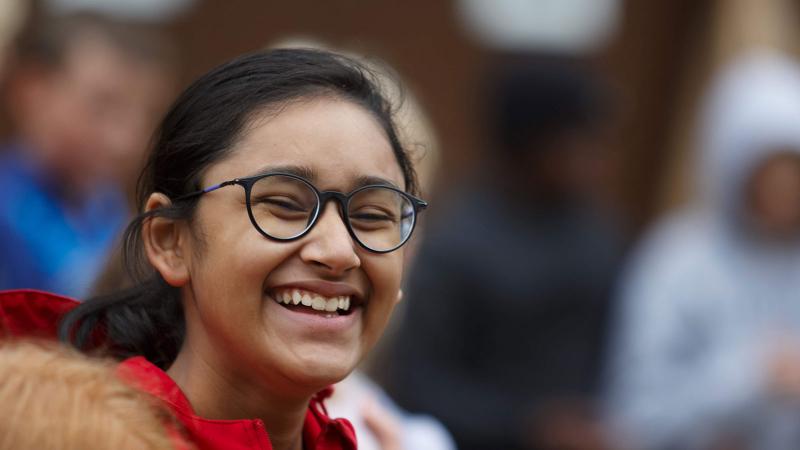 Picture of a student smiling outdoors during a House activity