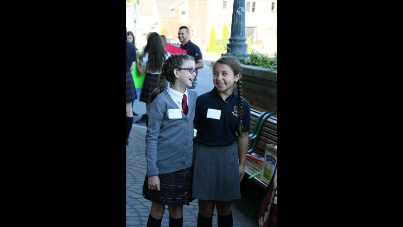 Picture of two students looking at each other and laughing