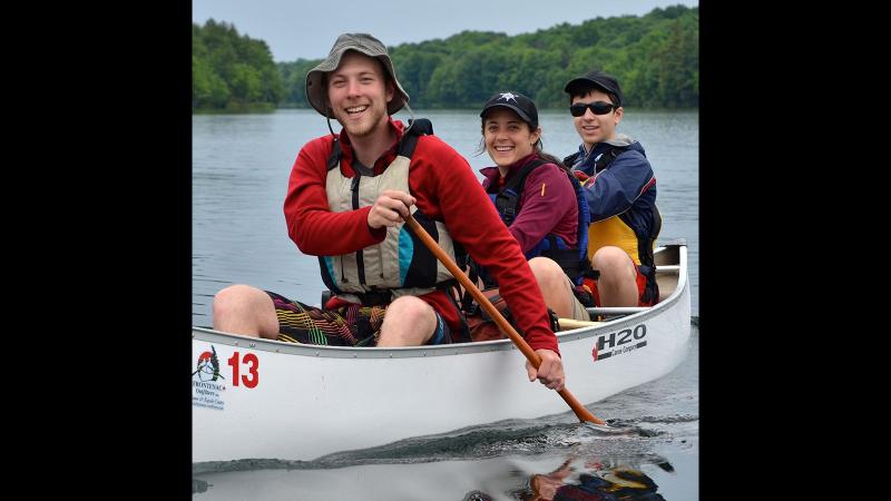 Picture of group of student and faculty campers in a canoe