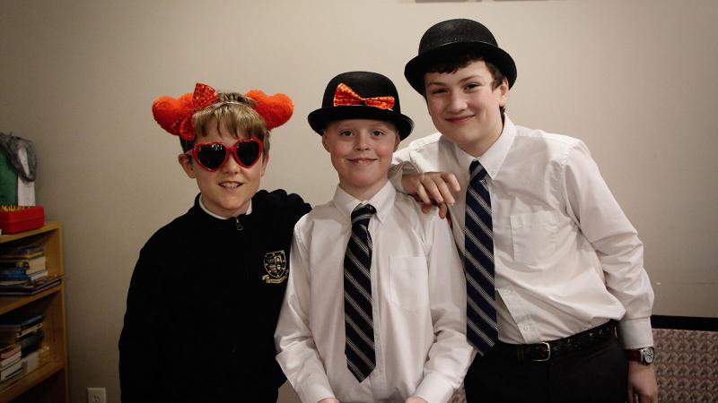 Picture of three students wearing silly hats and posing for a photo