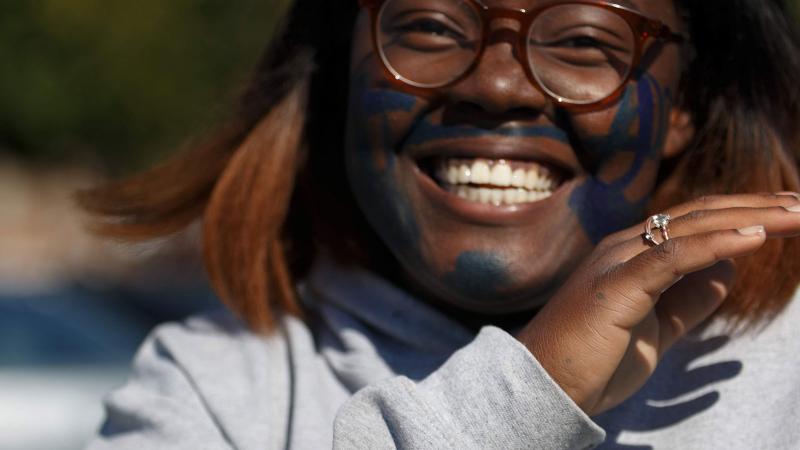 Picture of a student smiling outdoors during a House activity