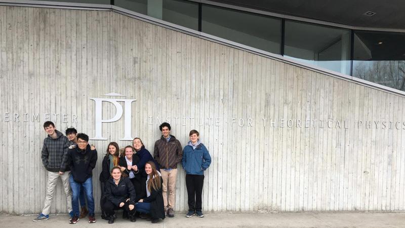 Picture of ten students posing for a photo in front of the PI Institute for Theoretical Physics