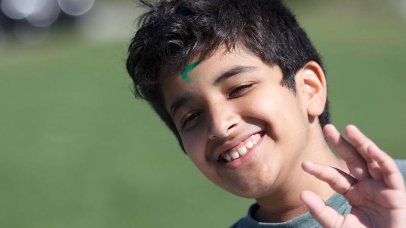 Picture of a student smiling outdoors during a House activity