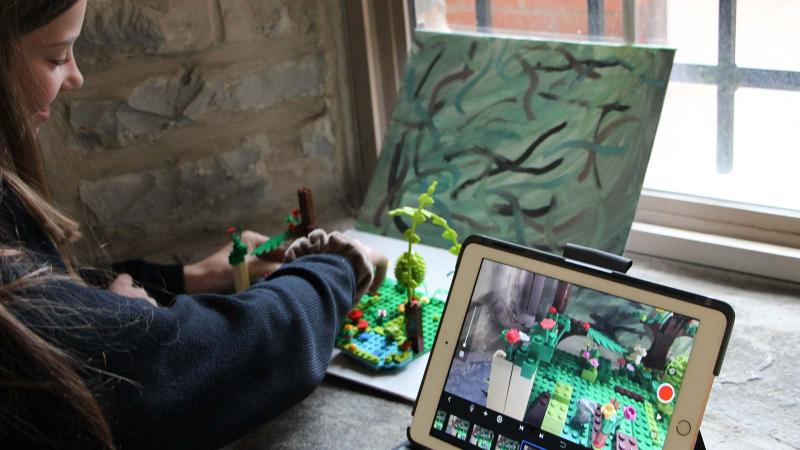 Picture of a student working on a lego art project