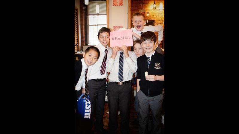 Picture of students holding up a #Be Nice sign