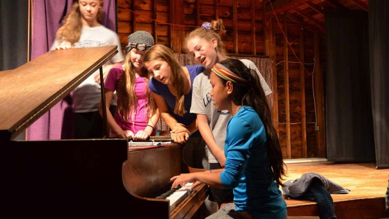 Picture of a group of student playing the piano
