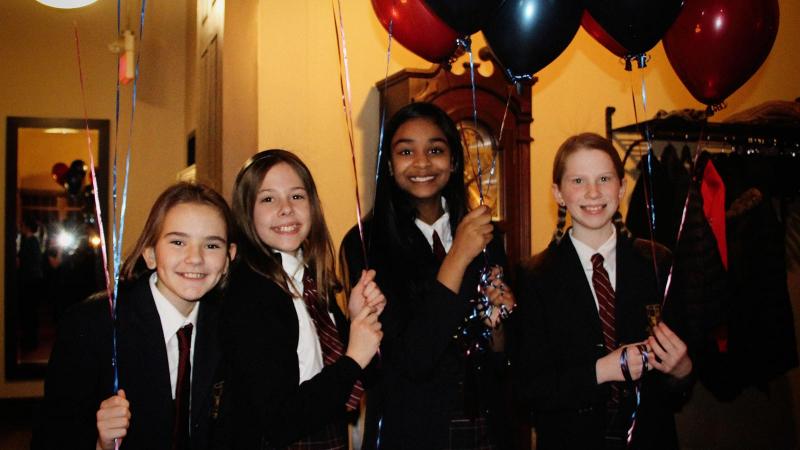 Picture of four students smiling