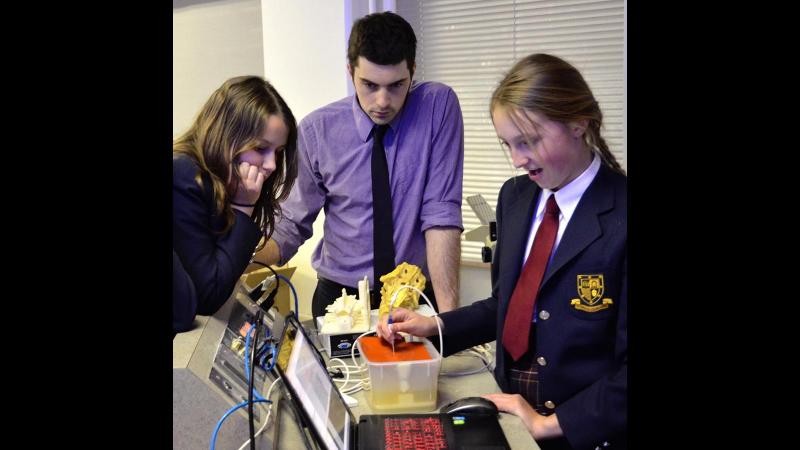 Picture of two students working on electronics during a field trip