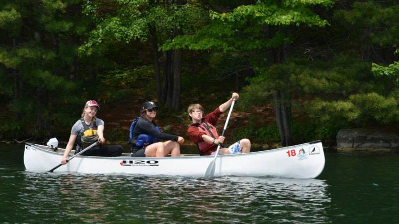 Picture of three students in a canoe