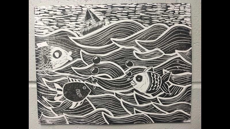 Picture of a black and white student artwork depicting fish in water