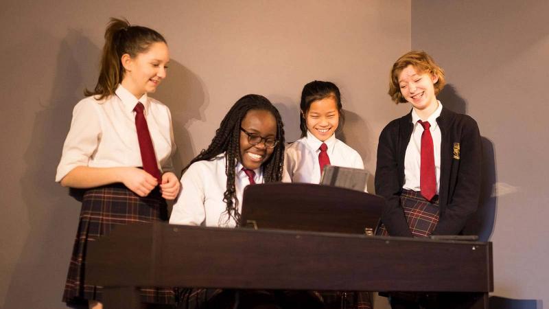 Picture of a group of student playing the piano