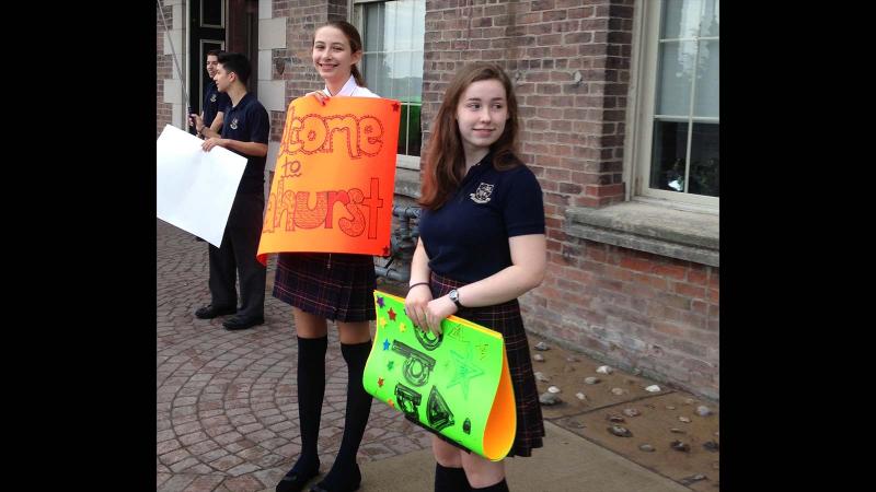 Picture of students holding up school spirit signs