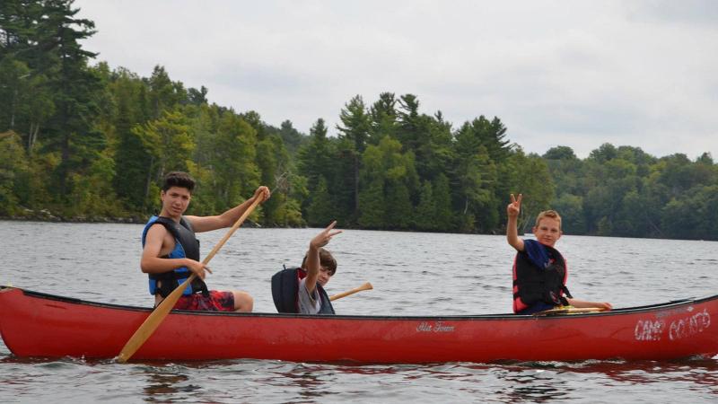 Picture of three students in a canoe