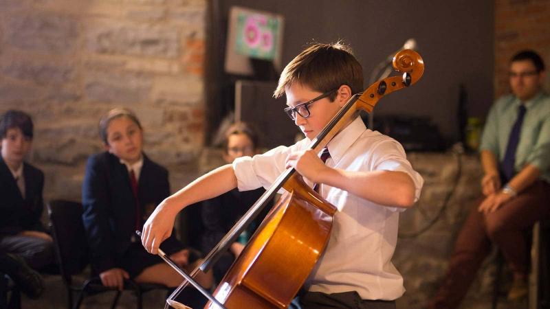 Picture of a boy playing the bass violin