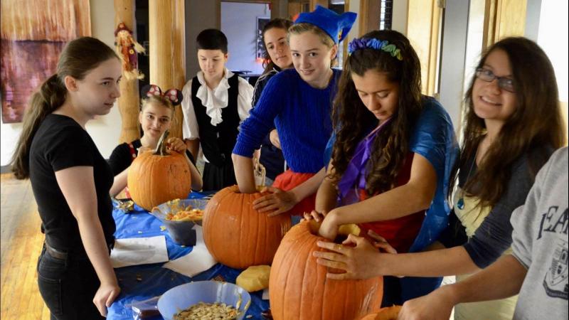Picture of students carving pumpkins