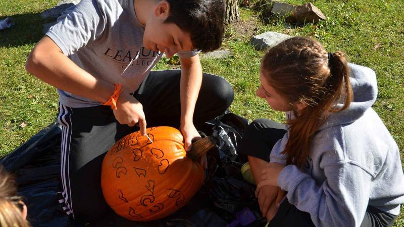 Picture of students carving pumpkins