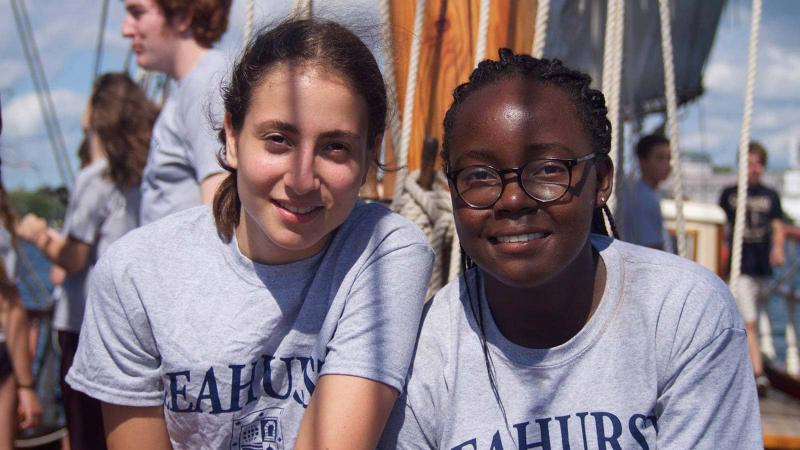 Picture of two students on a boat