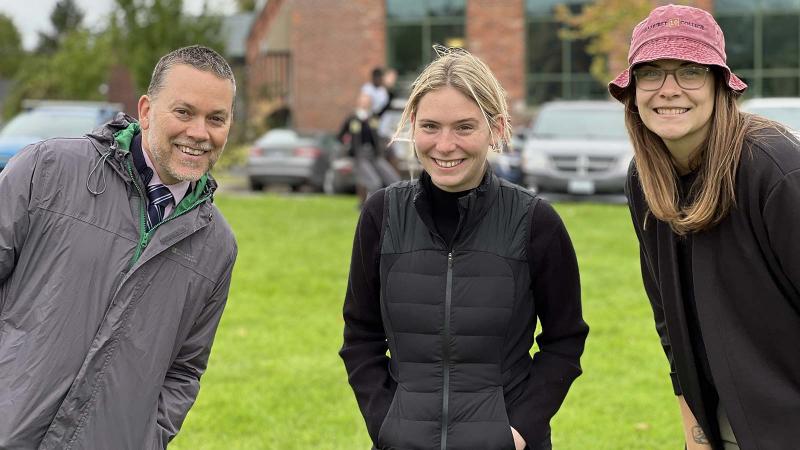 Picture of three teachers on the school field